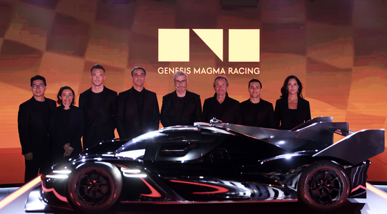 From left: Genesis Business Division Vice President Song Min-gyu, brand ambassador Vanina Ickx, driver André Lotterer, Hyundai Motor Sports head Cyril Abiteboul, Hyundai Motor Group Chief Creative Officer Luc Donckerwolke, brand partner and former Formula 1 driver Jacky Ickx, Genesis Magma driver Luis Felipe Derani and Genesis North America Chief Operating Officer Claudia Marquez pose with a Genesis GMR-001 hypercar model in Dubai on Wednesday. [GENESIS]