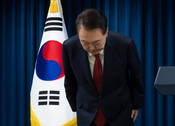 President Yoon Suk Yeol bows his head as he makes a public apology in a televised address from the Yongsan presidential office in Seoul Saturday. [PRESIDENTIAL OFFICE] 