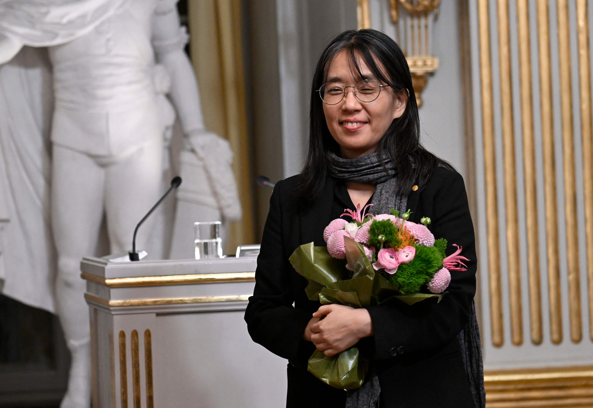 Han Kang receives applause on stage next to Mats Malm, Permanent Secretary of the Swedish Academy during this year's Nobel Prize lecture in literature at the Swedish Academy, on Saturday in Stockholm, Sweden. [AFP]