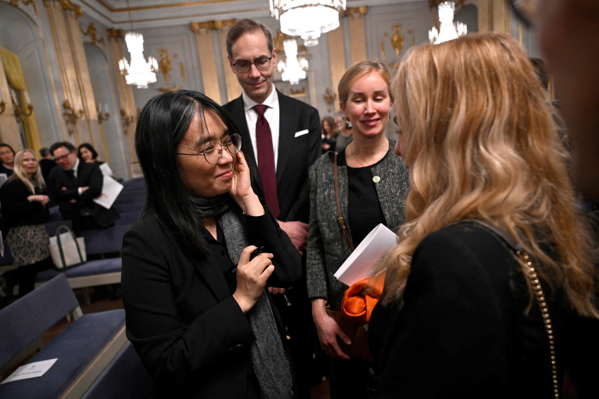 Han Kang gives autographs after this year's Nobel Prize lecture in literature at the Swedish Academy, on Saturday in Stockholm, Sweden. [AFP]