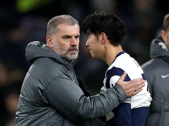Tottenham Hotspur manager Ange Postecoglou, left, and Son Heung-min look dejected after a match against Chelsea at Tottenham Hotspur Stadium in London on Sunday. [REUTERS/YONHAP] 