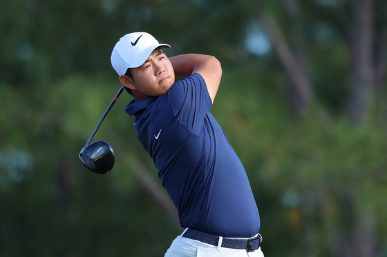 Tom Kim plays his shot from the 13th tee during the final round of the Hero World Challenge 2024 at Albany Golf Course in Nassau, Bahamas, on Sunday. [AFP/YONHAP] 