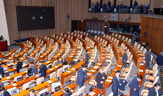 Democratic Party lawmakers leave the main chamber of the National Assembly in western Seoul after an impeachment motion to oust President Yoon Suk Yeol failed Saturday. [NEWS1]