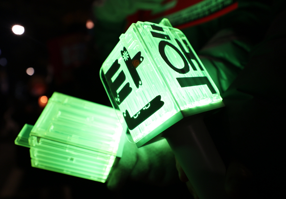 Fans of K-pop boy band NCT brought their light sticks with the word ″impeachment″ written on them during a rally held in front of the National Assembly in Yeouido District, western Seoul, on Friday. [YONHAP] 