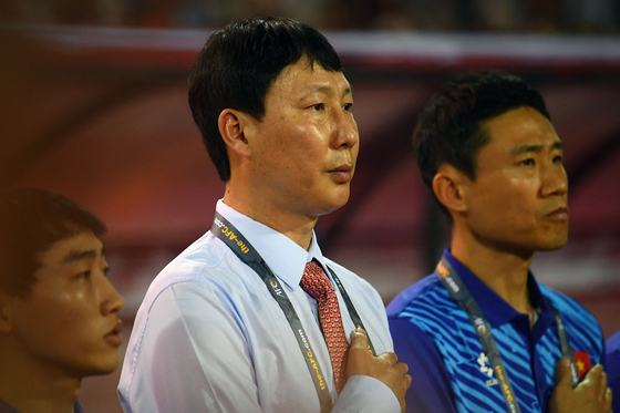 Vietnamese national team manager Kim Sang-sik listens to the national anthem before a 2026 FIFA World Cup AFC qualifier against the Philippines at the My Dinh National Stadium in Hanoi, Vietnam on June 6. [AFP/YONHAP] 