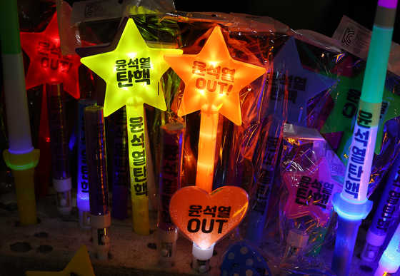 Light sticks with ″Impeach″ written on them are displayed at a rally demanding Yoon's ousting in front of the National Assembly in western Seoul on Saturday. [YONHAP] 