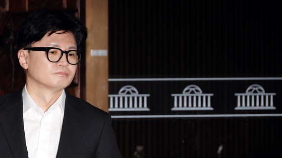 Conservative People Power Party leader Han Dong-hoon walks out from the parliamentary chamber where the party's general assembly was convened on Saturday in western Seoul. [YONHAP] 