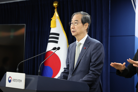 Prime Minister Han Duck-soo, Korea's acting president, makes his first public address from the government complex in Jongno District, central Seoul, Saturday, after the National Assembly passed an impeachment motion against Yoon Suk Yeol. [NEWS1]