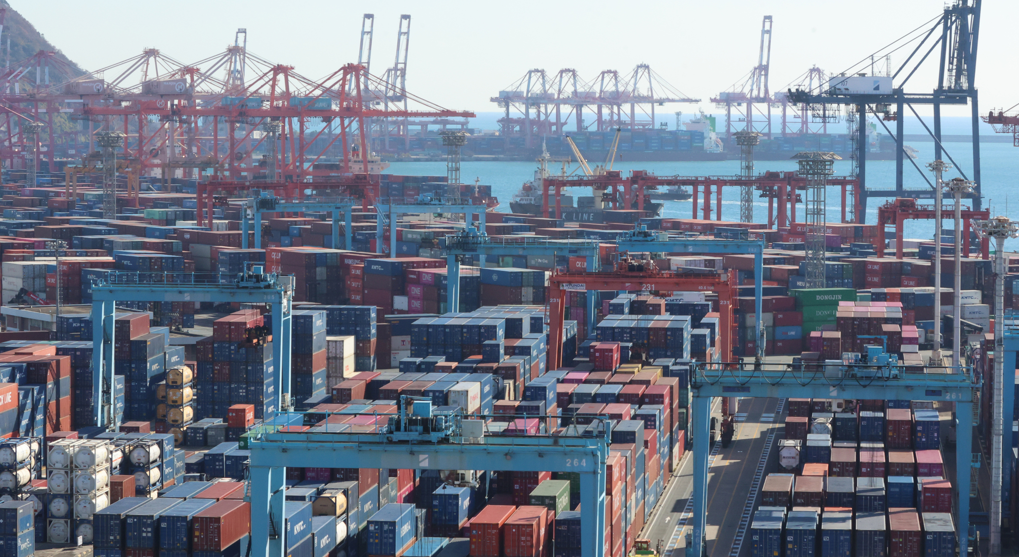 Shipping containers are stacked at a port in the southeastern city of Busan. [YONHAP] 