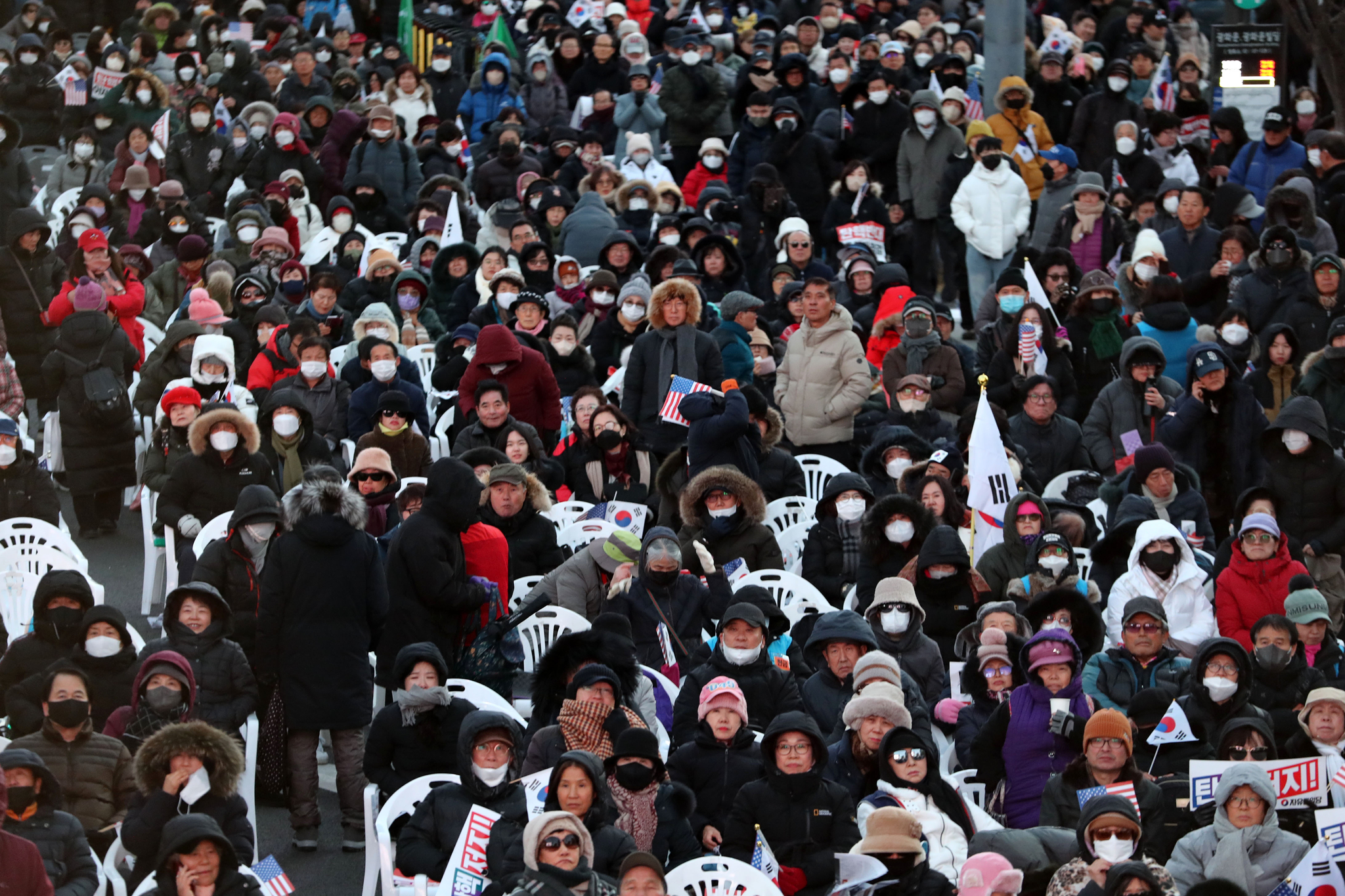 Protesters from conservative groups supporting Yoon listen to the impeachment vote result with solemn expressions in central Seoul on Saturday. [NEWS1] 