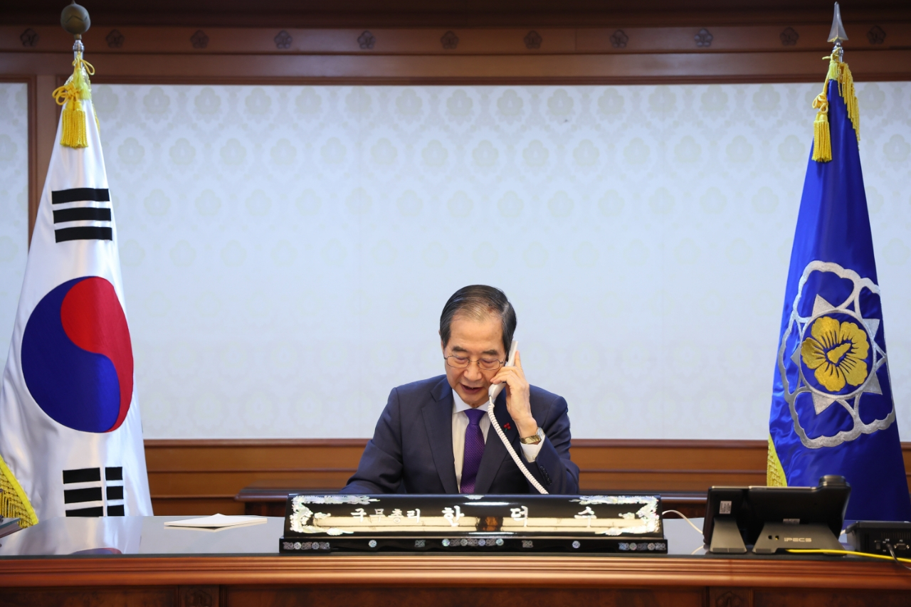 Acting President and Prime Minister Han Duck-soo talks on the phone with U.S. President Joe Biden on Dec. 15. [OFFICE FOR GOVERNMENT POLICY COORDINATION] 