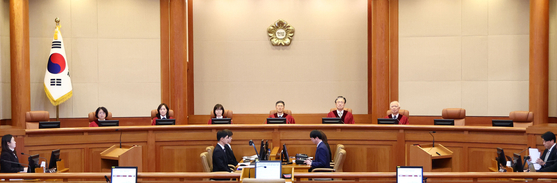 Six Constitutional Court justices are seated in the courtroom of the Constitutional Court in Jongno District, central Seoul, on Dec. 10. [YONHAP]