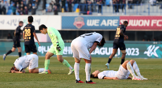 Busan IPark, in white, react during the K League promotion-relegation playoff against Suwon FC at Suwon Sports Complex in Suwon, Gyeonggi on Dec. 9, 2023. [NEWS1] 