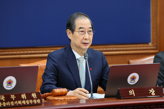 Acting President Han Duck-soo speaks during a Cabinet meeting at the government complex in Seoul on Dec. 24. [NEWS1]