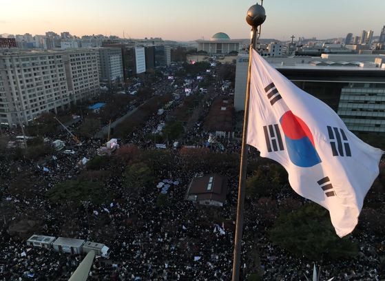 Protestors are seen in front of the National Assembly building in Yeouido, western Seoul, on Dec. 14, ahead of the second impeachment vote against President Yoon Suk Yeol [YONHAP]