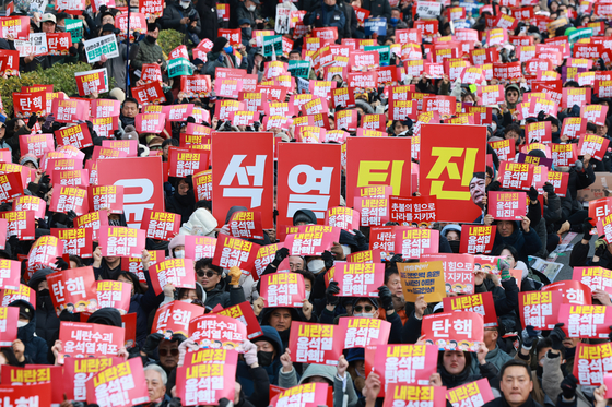 People attend a rally calling for President Yoon Suk Yeol's impeachment over his short-lived martial law imposition. [YONHAP]