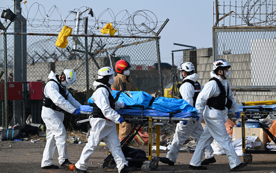 Rescuers operate at the site of an airplane crash at the Muan International Airport on Dec. 29. [XINHUA/YONHAP]