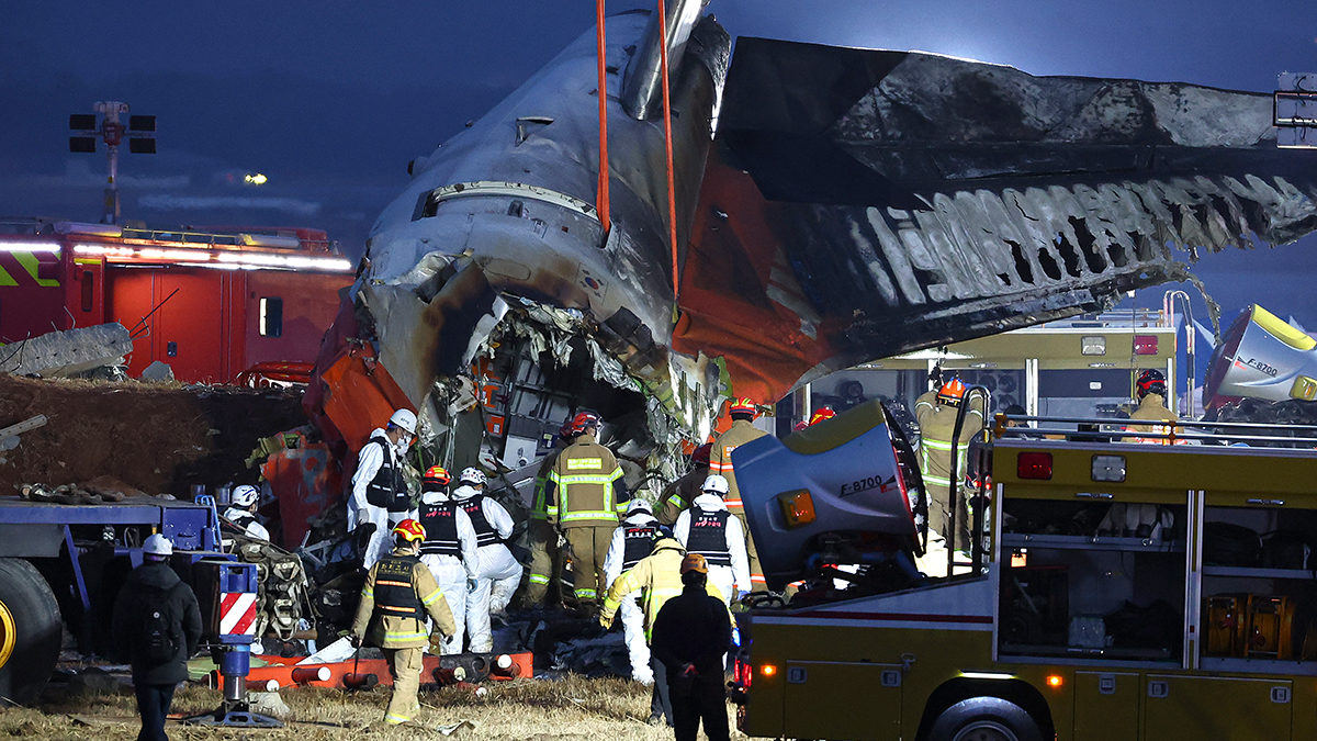 Firefighters search the site of the deadly plane crash at Muan International Airport in South Jeolla on Dec. 30. [YONHAP]
