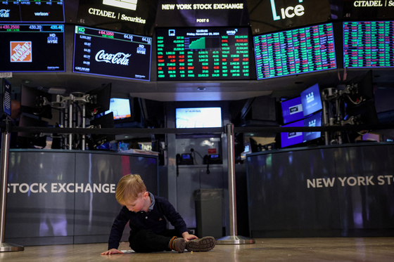 A child plays on the floor during the trading day on the traditional bring-your-kids-to-work day on the floor at the New York Stock Exchange (NYSE) in New York City, U.S., November 29, 2024. [YONHAP/REUTERS]