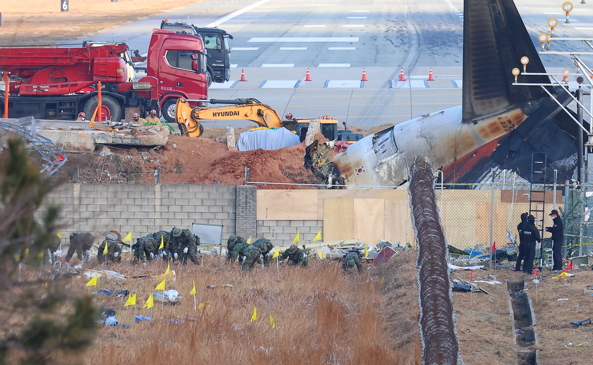 Soldiers conduct a search mission at the Jeju Air crash site at Muan International Airport in South Jeolla on Jan. 3. [YONHAP] 