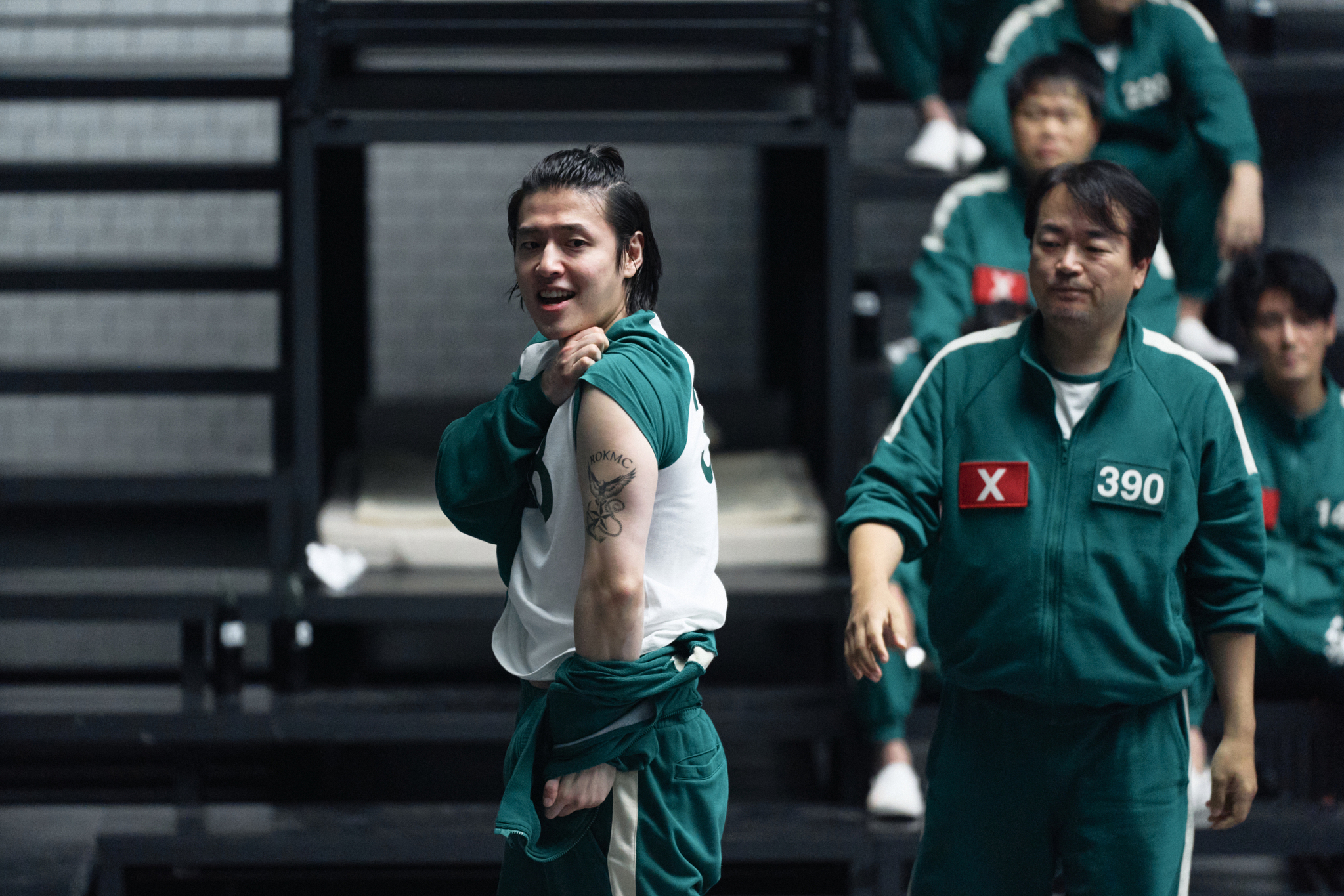 Still from the second season of Netflix ″Squid Game″ (2021-), where Dae-ho, portrayed by Kang Ha-neul, shows off his Marine Corps tattoo. [NETFLIX]