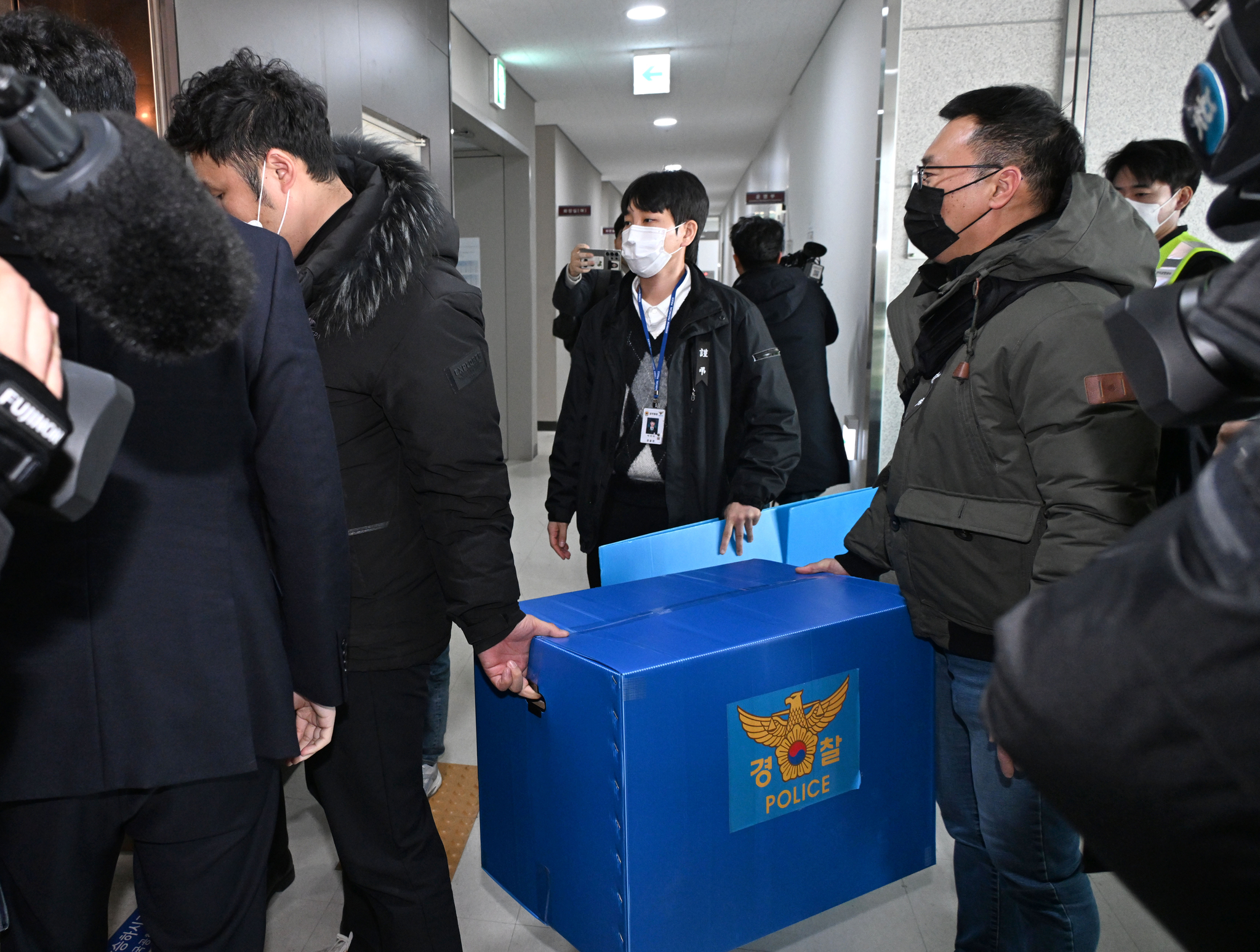 Police officials leave Muan International Airport in Musan, South Jeolla, on Thursday after raiding the airport. [JOINT PRESS CORPS]