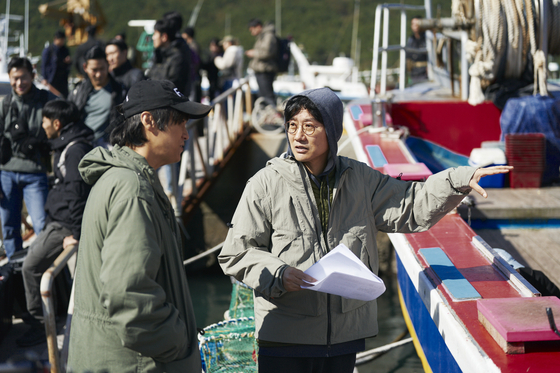 Director Hwang Dong-hyuk, right, gives directions during filming of the second season of the Netflix hit series ″Squid Game″ [NETFLIX]      