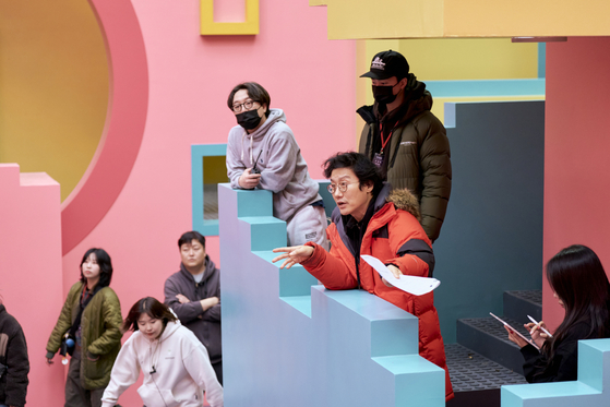 Director Hwang Dong-hyuk, center, gives directions during filming of the second season of the Netflix hit series ″Squid Game″ [NETFLIX]   