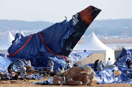 Authorities investigate and clear the Jeju Air crash site at Muan International Airport in South Jeolla on Jan. 8. [YONHAP] 