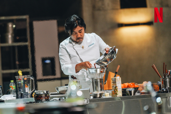 Edward Lee cooks as a contestant in ″Culinary Class Wars,″ a 2014 Netflix cooking survival show. [NEFTLIX]