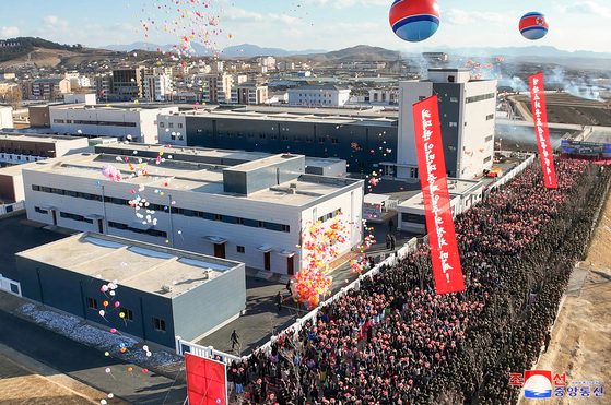This photo, released by North Korea's official Korean Central News Agency on Jan. 8, 2025, shows North Korean residents taking part in the inauguration ceremony of a regional factory in Jaeryong County, South Hwanghae, the previous day with leader Kim Jong-un in attendance. [YONHAP]