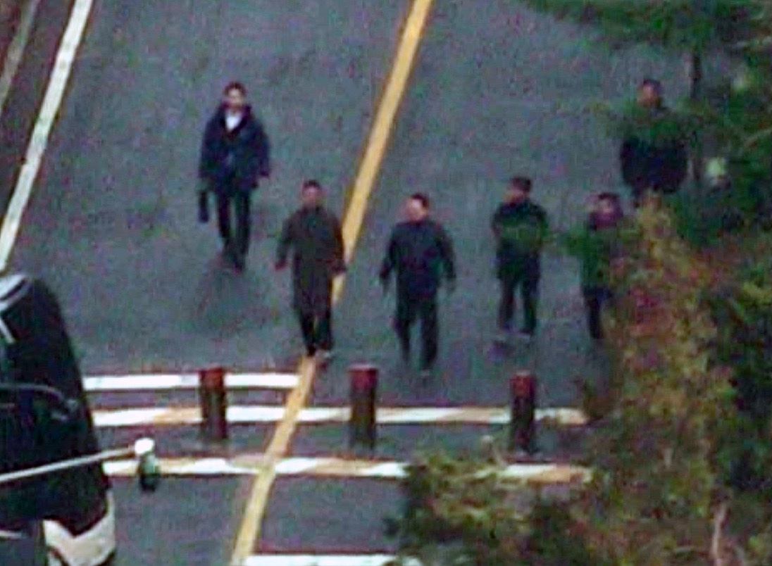 An individual that is allegedly President Yoon Suk Yeol, third from left, walks to the gate of the presidential residence on Jan. 8. [SCREEN CAPTURE]