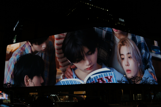 Shinsegae Department Store's media facade in Myeong-dong, Jung District, central Seoul, lights up Shinsegae Square with boy band BoyNextDoor's ″If I say, I love you″ music video on Jan. 6. Highlights of the video will air on the screen through Jan. 12. [KIM JU-YEON]