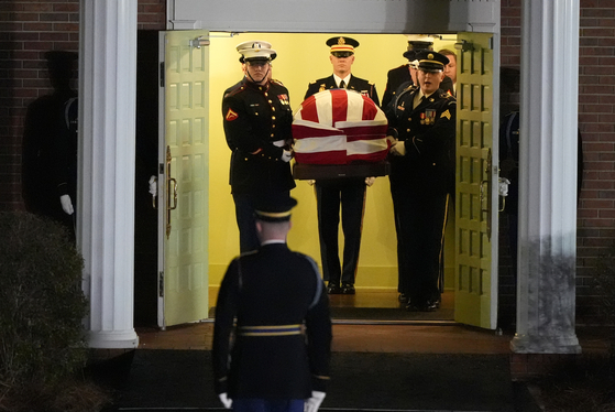 The flag-draped casket of former President Jimmy Carter is carried to a hearse after a funeral service at Maranatha Baptist Church, on Jan. 9. [AP]