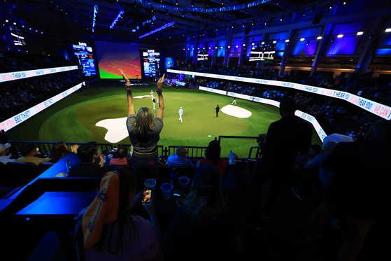 A fan cheers in the stands during play on the the ninth hole during the TGL presented by SoFi match between the New York Golf Club and The Bay Golf Club at SoFi Center in Palm Beach, Florida on Jan. 7.  [TGL]
