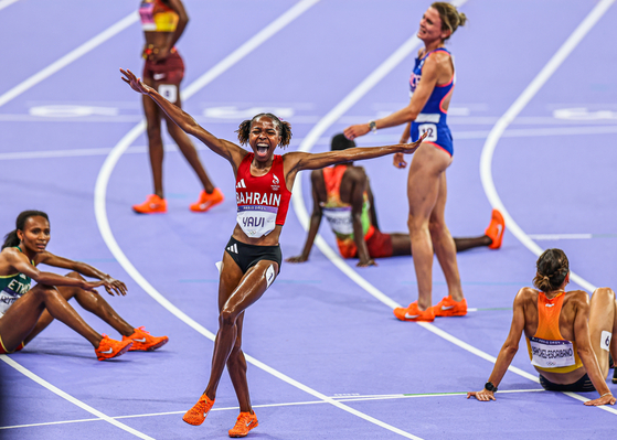 Olympic Gold - Gold Medal - Athletics. Winfred Yavi celebrates winning Olympic gold in the 3,000-meter steeplechase.  [DANIEL SANNUM LAUTEN/WSPA]