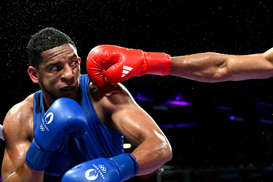 Eyeing a punch - Gold Medal - Boxing. Enmanuel Reyes Pla of Spain is punched by Belgium’s Victor Schelstraete in the men’s 92-kilogram Olympic boxing.  [MOHD RASFAN/WSPA]