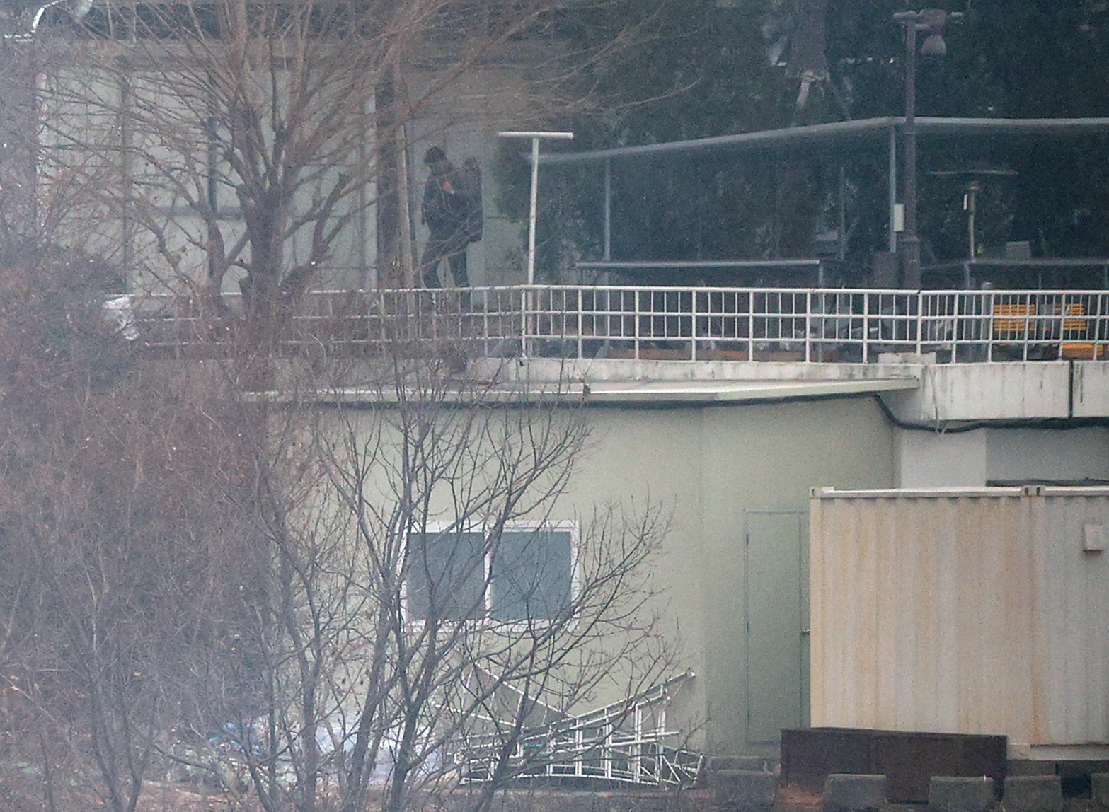 A person believed to be a security guard patrols at impeached President Yoon Suk Yeol's official residence in Seoul on Jan. 13, one week after a court issued a second warrant to detain Yoon in connection to his short-lived imposition of martial law. [YONHAP]