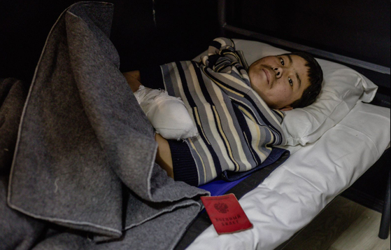 Suspected North Korean soldiers wounded and captured by Ukrainian forces are seen in this photo posted on Ukrainian President Volodymyr Zelensky's Telegram channel on Jan. 11. [SCREEN CAPTURE]
