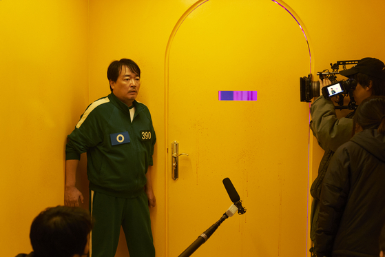 A behind-the-scenes still from season two of Netflix's ″Squid Game″ (2021-) showing orange walls [NETFLIX]