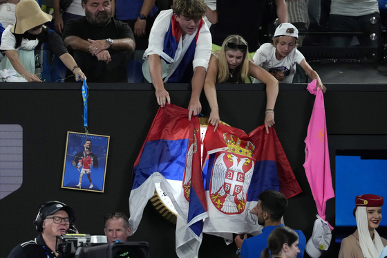 Novak Djokovic gives autographs to fans after defeating Jiri Lehecka in a fourth round match at the Australian Open tennis championship in Melbourne, Australia, Sunday, Jan. 19, 2025. [AP/YONHAP]