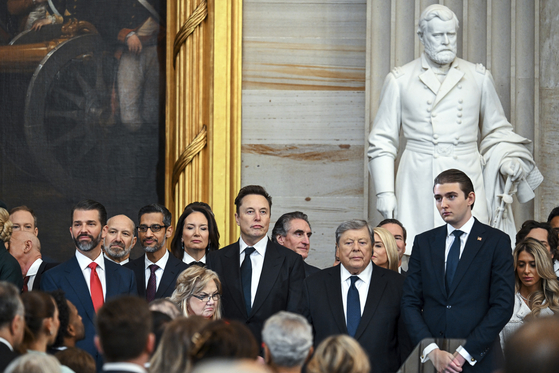 Donald Trump Jr., from left, Howard Lutnick, Sundar Pichai, Elon Musk, Viktor Knavs and Barron Trump arrive at the 60th Presidential Inauguration in the Rotunda of the U.S. Capitol in Washington, Jan. 20. [AP/YONHAP]