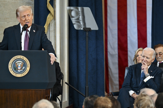 Former U.S. President Joe Biden, right, watches as U.S. President Donald Trump speaks after taking the oath of office at the 60th Presidential Inauguration in the Rotunda of the U.S. Capitol in Washington, Jan. 20. [AP/YONHAP]