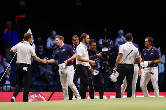 Atlanta Drive GC, in white, shake hands with New York Golf Club after their TGL match at SoFi Center on Jan. 21 in Palm Beach Gardens, Florida. [TGL] 