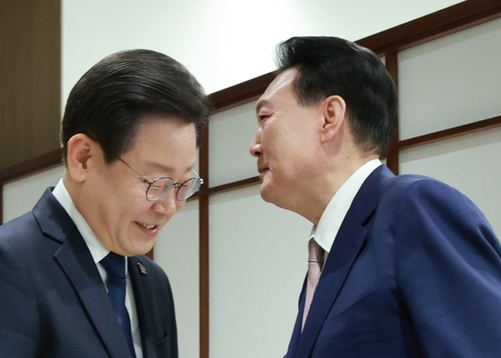 President Yoon Suk Yeol, right, greets Democratic Party leader Lee Jae-myung at the presidential office in Yongsan District, central Seoul, on April 29, 2024. [YONHAP]