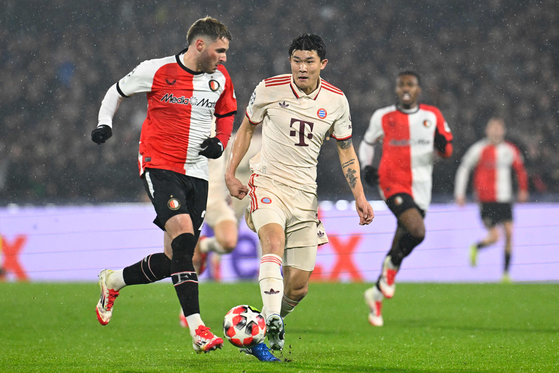 Bayern Munich defender Kim Min-jae, right, vies for the ball during the UEFA Champions League match against Feyenoord at Feyenoord Stadium in Rotterdam, Netherlands on Jan. 22. [AFP/YONHAP] 