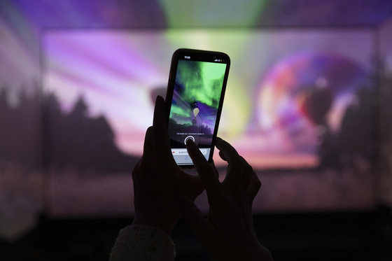 A person participates in interactive content during a screening at the new four-screen SCREENX theater at CGV Yongsan in central Seoul. [CGV] 