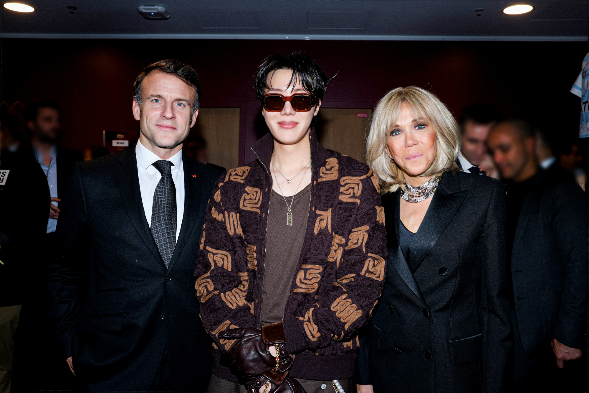 J-Hope, center, poses for a photo with French president Emmanuel Macron, left, and first lady Brigitte Macron at the charity event “Le Gala des Pièces Jaunes,” held on Jan. 23 at La Défense Arena in Paris. [BIGHIT MUSIC]