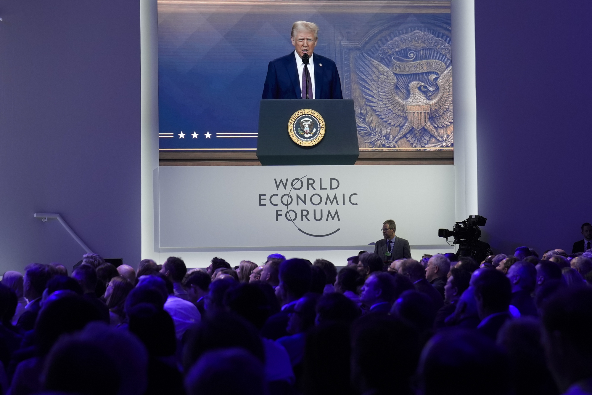 Attendees listen to a virtual speech delivered by U.S. president Donald Trump, at the Annual Meeting of World Economic Forum in Davos, Switzerland, on Jan. 23. [AP]