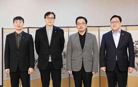 From left: Financial Supervisory Service Gov. Lee Bok-hyun, Bank of Korea Gov. Rhee Chang-yong, acting President Choi Sang-mok and Financial Services Commission Chairman Kim Byoung-hwan pose for a photo ahead of a meeting on macroeconomic and financial issues held at the government complex in central Seoul on Jan. 30. [MINISTRY OF ECONOMY AND FINANCE]